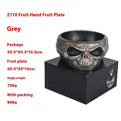 Motion-activated Halloween pumpkin candy bowl with lighted red eyes and skeleton hand in grey colour