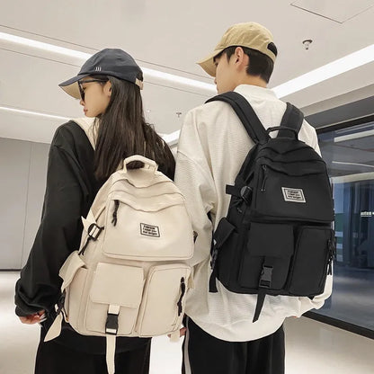 Black and white nylon student backpack with laptop compartment and three-dimensional pocket.