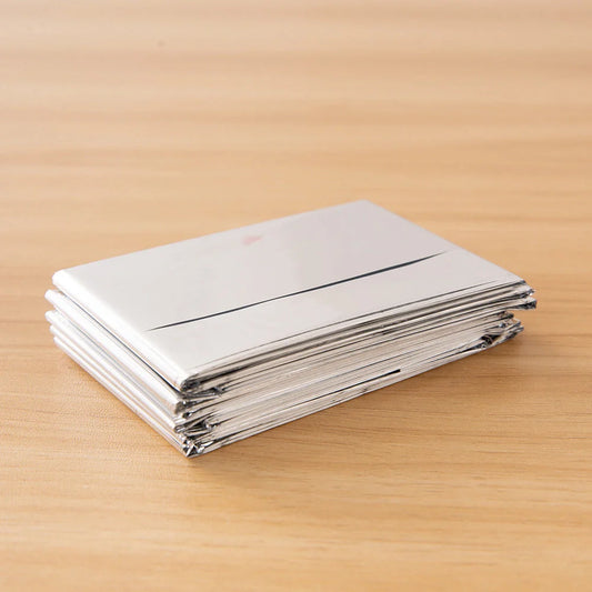 Portable double-sided silver emergency thermal blanket for outdoor adventures and survival situations