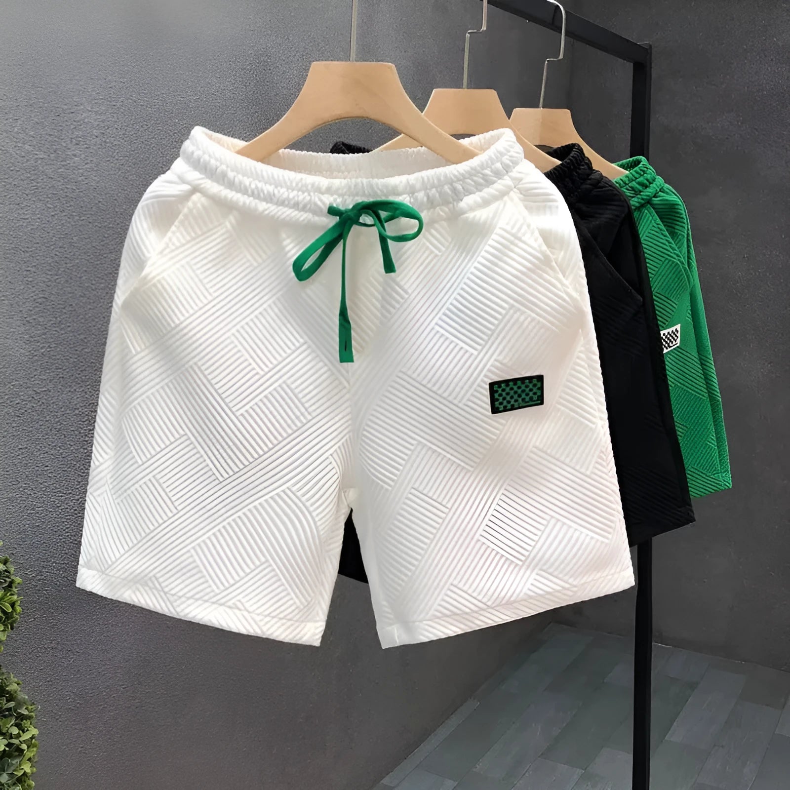 Men's solid colour polyester sports shorts with micro-elasticity, shown in black.