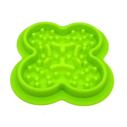 A raised silicone pet licking pad placed on a floor, showing its textured surface and non-slip base.
