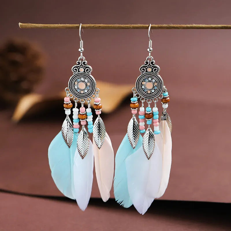 Round drop feather earrings in a bohemian leaf shape with patterned detail, shown in a light pink electroplated colour.