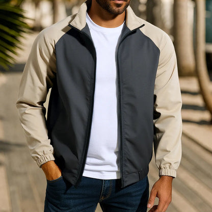 Man wearing a green loose-fit casual jacket with a stand collar and raglan long sleeves.