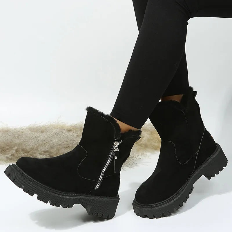 Women's black faux suede high-top snow boots with a side zipper and fur-lined collar.
