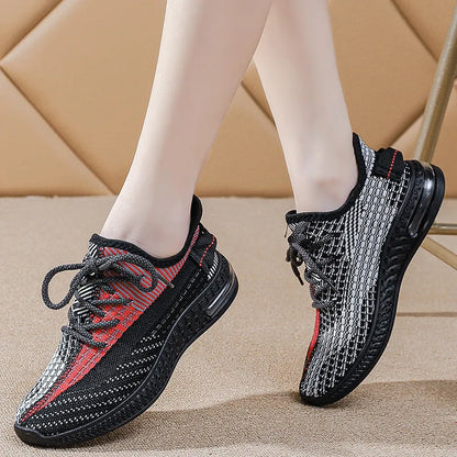 Women's casual running shoes in purple, black, and orange colours with fabric lining and plastic sole