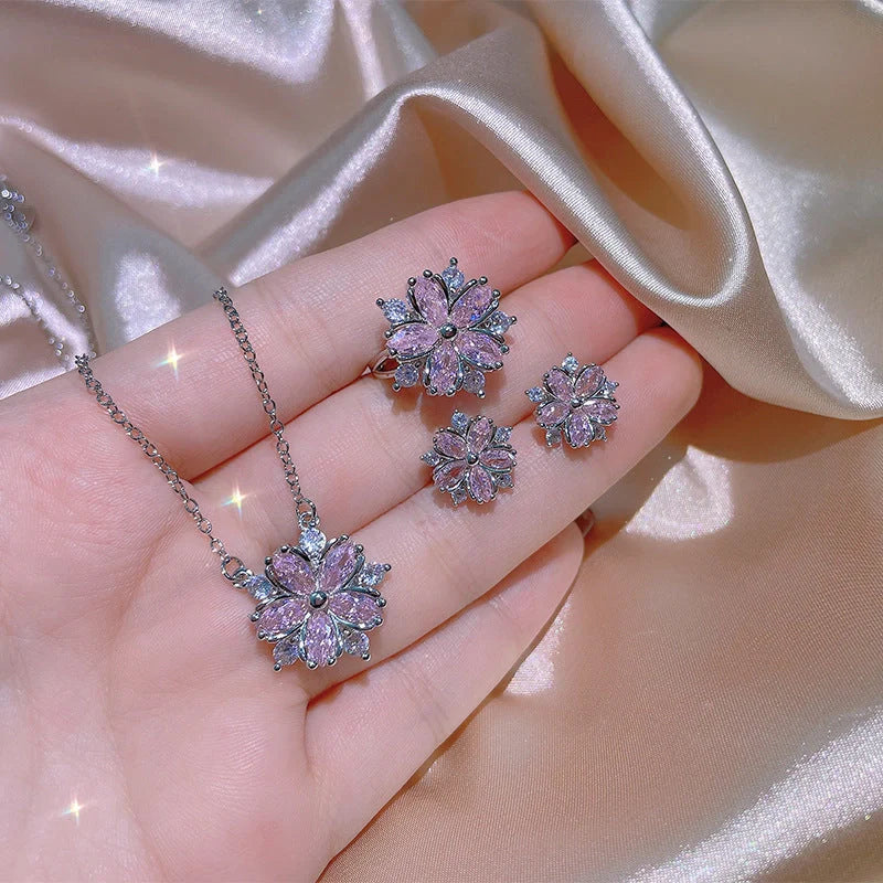 Dazzling cubic zirconia jewellery set with double-layered flower design, including ring, necklace, and earrings in pink and white diamond colours