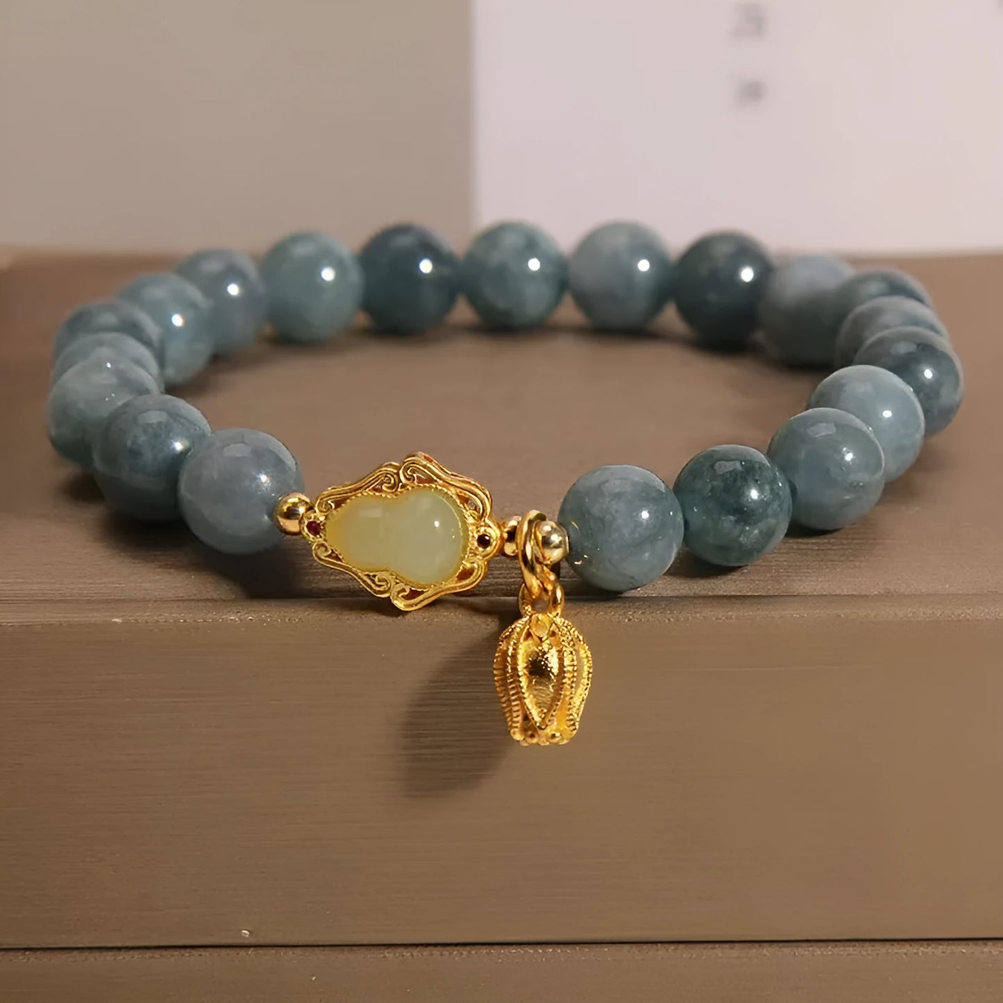 Women's natural stone bracelet with sky blue carved gourd and lotus pendant