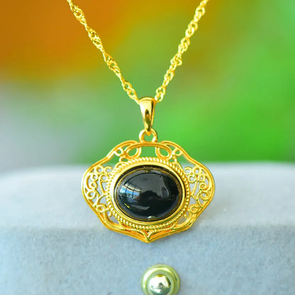 Copper inlaid pendant with natural grey Hetian jade and dark ink blue jade on a necklace.
