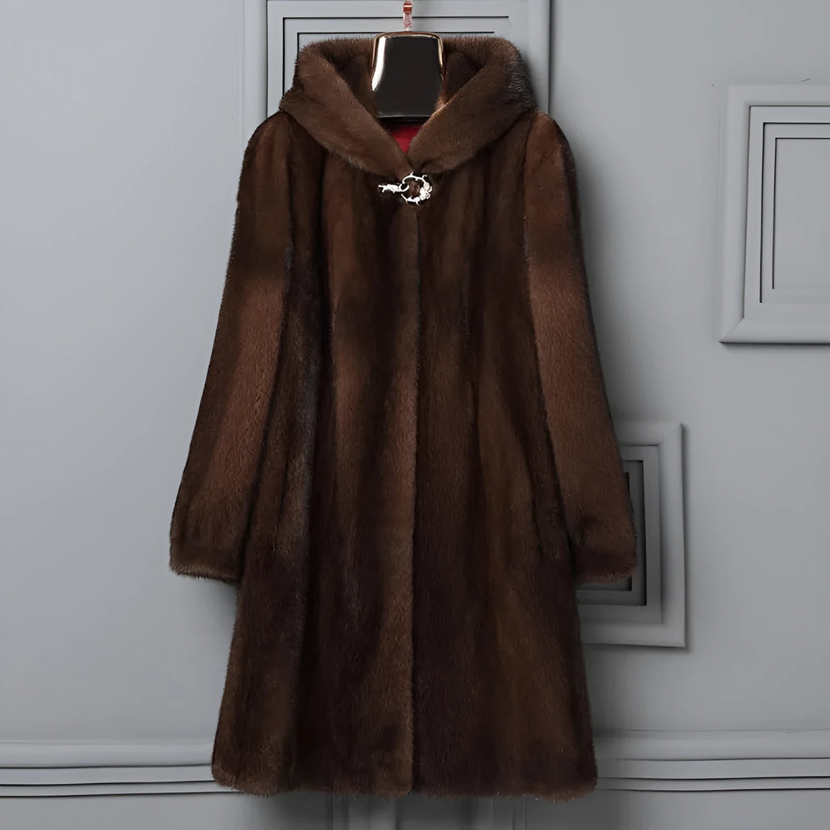 Woman wearing a long black faux fur hooded coat in a street fashion style.