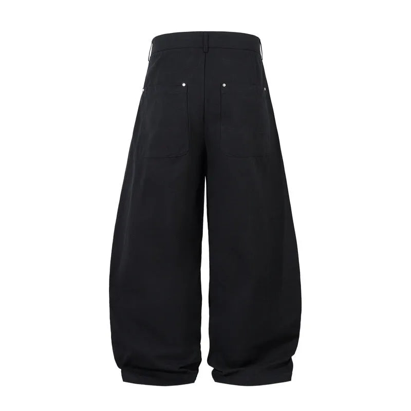 Men's black cotton pleated casual trousers with a loose-fitting wide-leg silhouette.