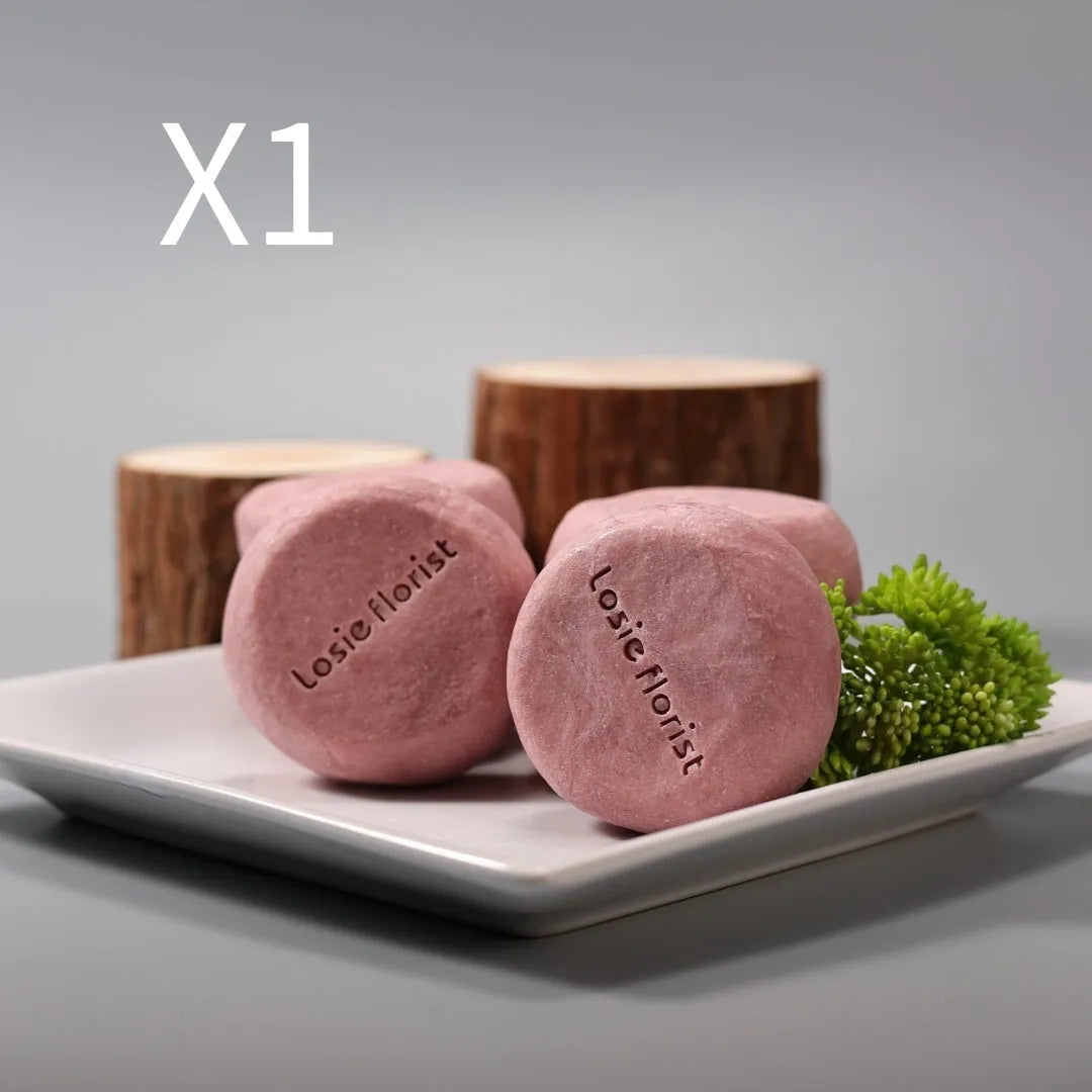 Pink round handmade rosewood grinding soap with roselle and tangerine peel ingredients