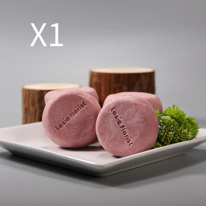 Pink round handmade rosewood grinding soap with roselle and tangerine peel ingredients