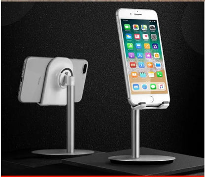 Silver metal desktop stand holding tablet and phone for hands-free viewing