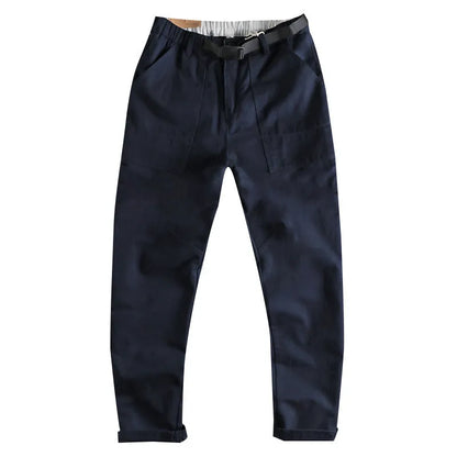 Men's khaki work trousers with a three-dimensional cut and an N I buckle belt on a hanger.