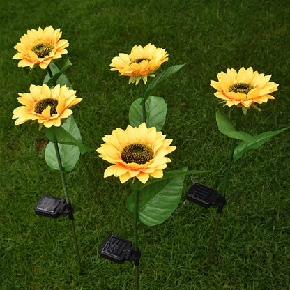 Elegant solar-powered sunflower lamps illuminating a serene outdoor garden pathway