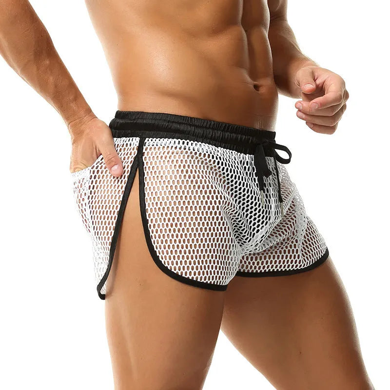 Men's solid colour loose fit polyester boxer shorts shown in black, white, grey, and red.