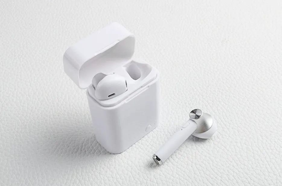 Black wireless sports Bluetooth earbuds showing battery display and placed next to a smartphone.