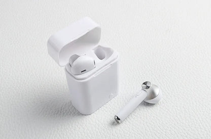 Black wireless sports Bluetooth earbuds showing battery display and placed next to a smartphone.