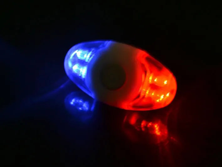 Red and blue LED tail light with adjustable mounting base shown in horizontal and vertical positions.