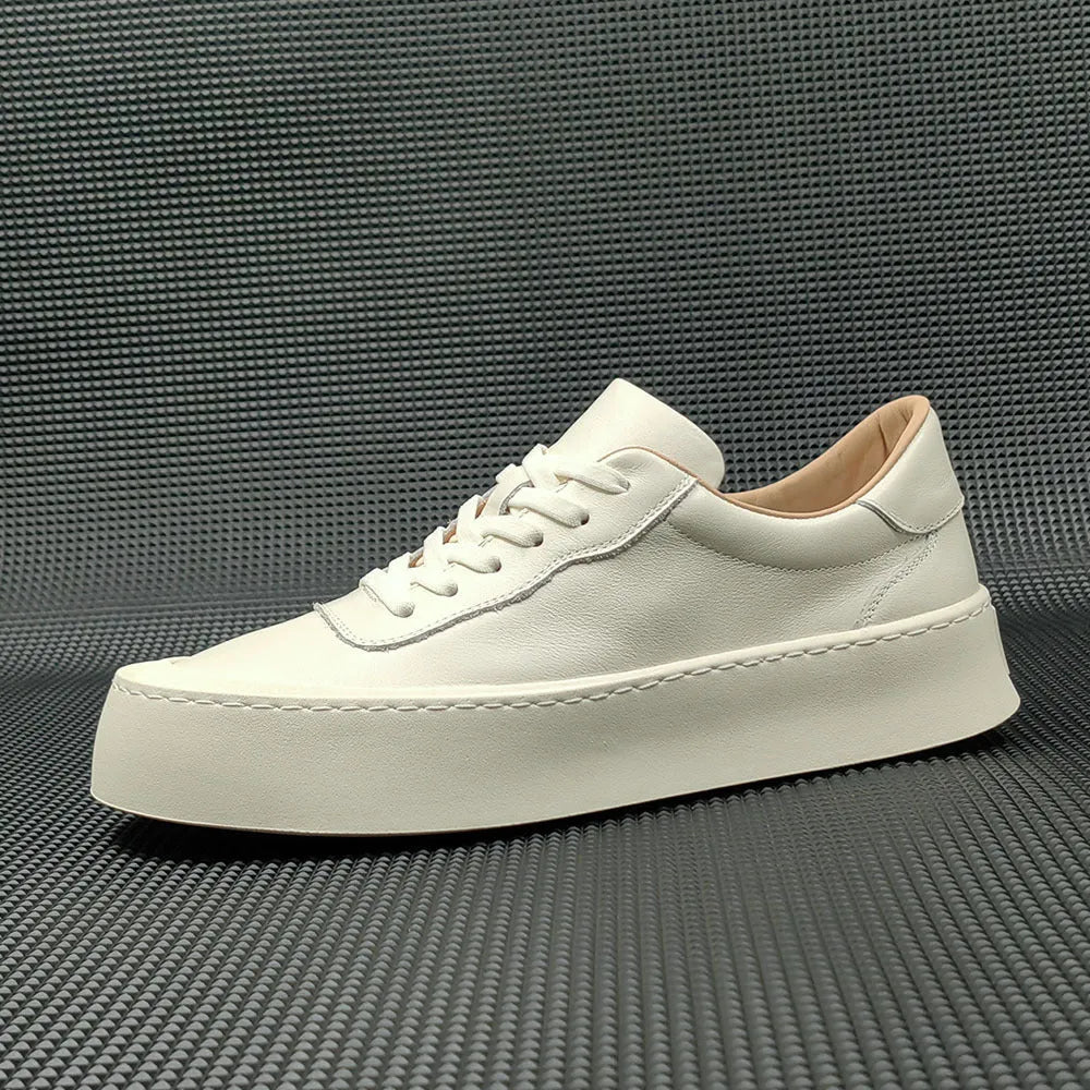 Men's white genuine cowhide board shoes with a thick rubber platform sole and round toe.