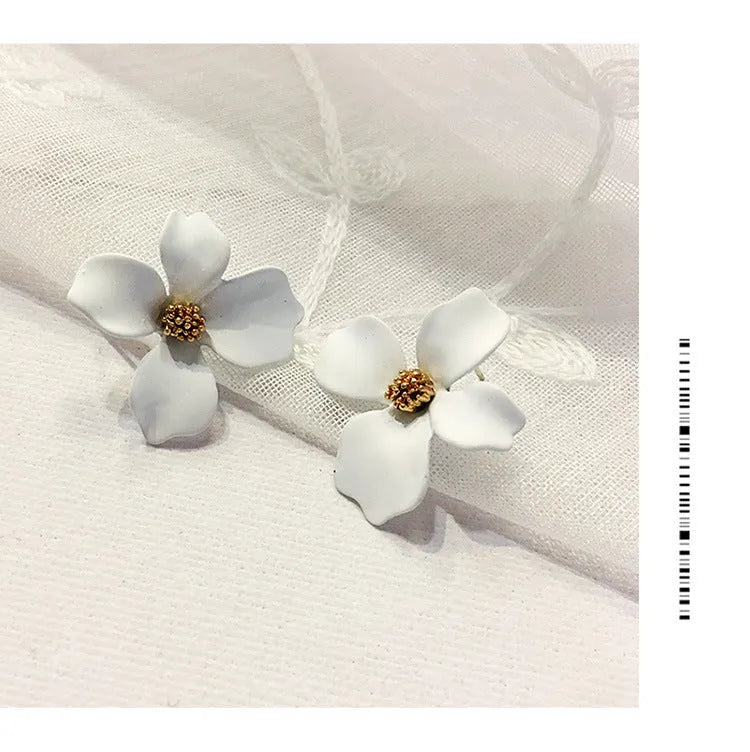 A pair of women's flower-shaped alloy stud earrings with a white electroplated finish.