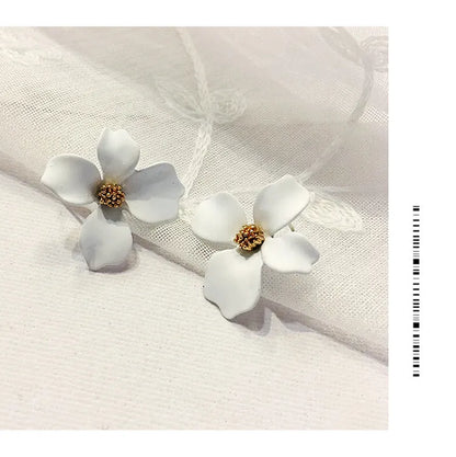 A pair of women's flower-shaped alloy stud earrings with a white electroplated finish.