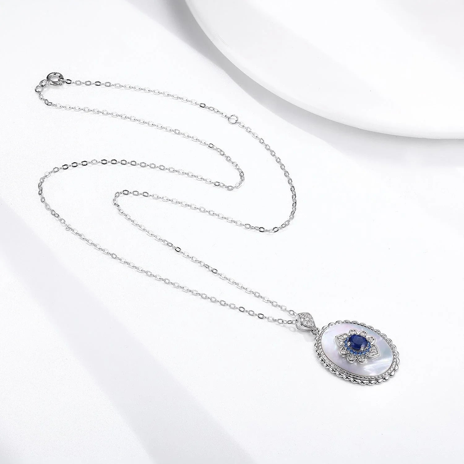 Elegant sapphire and diamond pendant necklace in 925 sterling silver, featuring a sparkling gemstone design and adjustable chain.