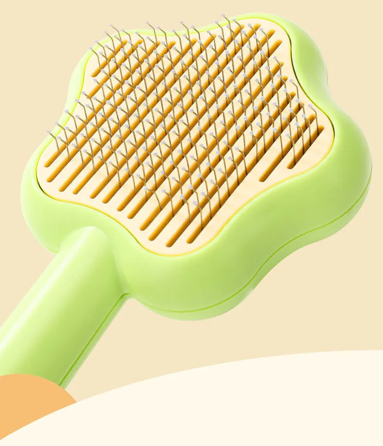 Green and yellow stainless steel self-cleaning cat comb for de-shedding, measuring 20cm.