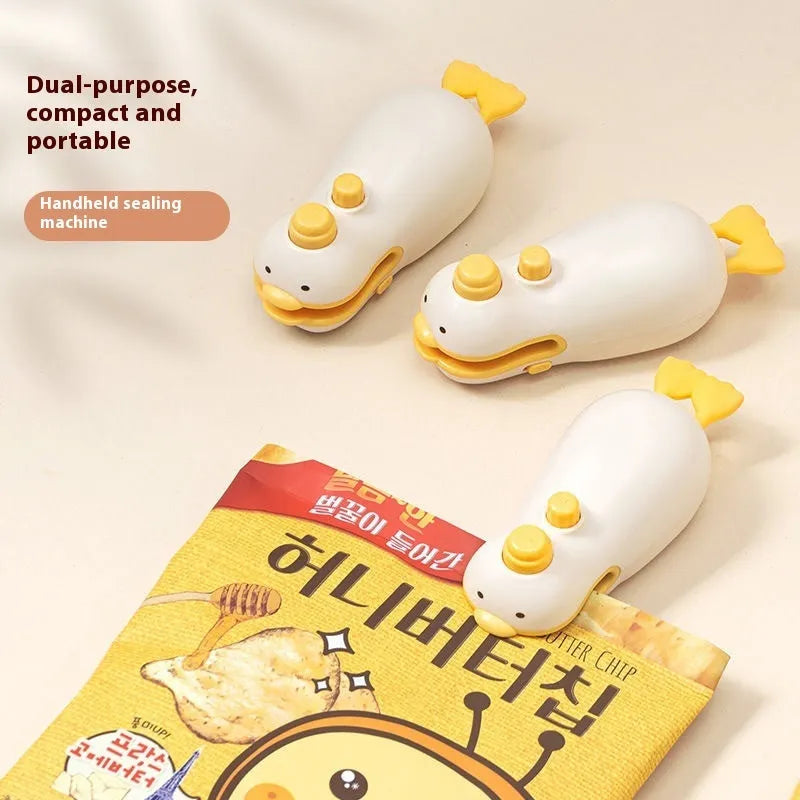 Small yellow duck shaped rechargeable handheld sealing machine with USB cable.