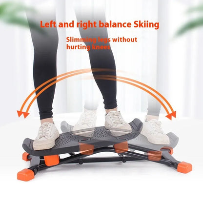 Black JS101A mini indoor skiing exercise machine with elastic hand straps on a carpet.