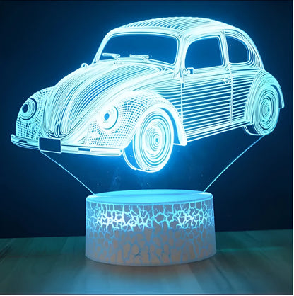 Colourful 3D LED table lamp with remote control and USB cable on wooden desk
