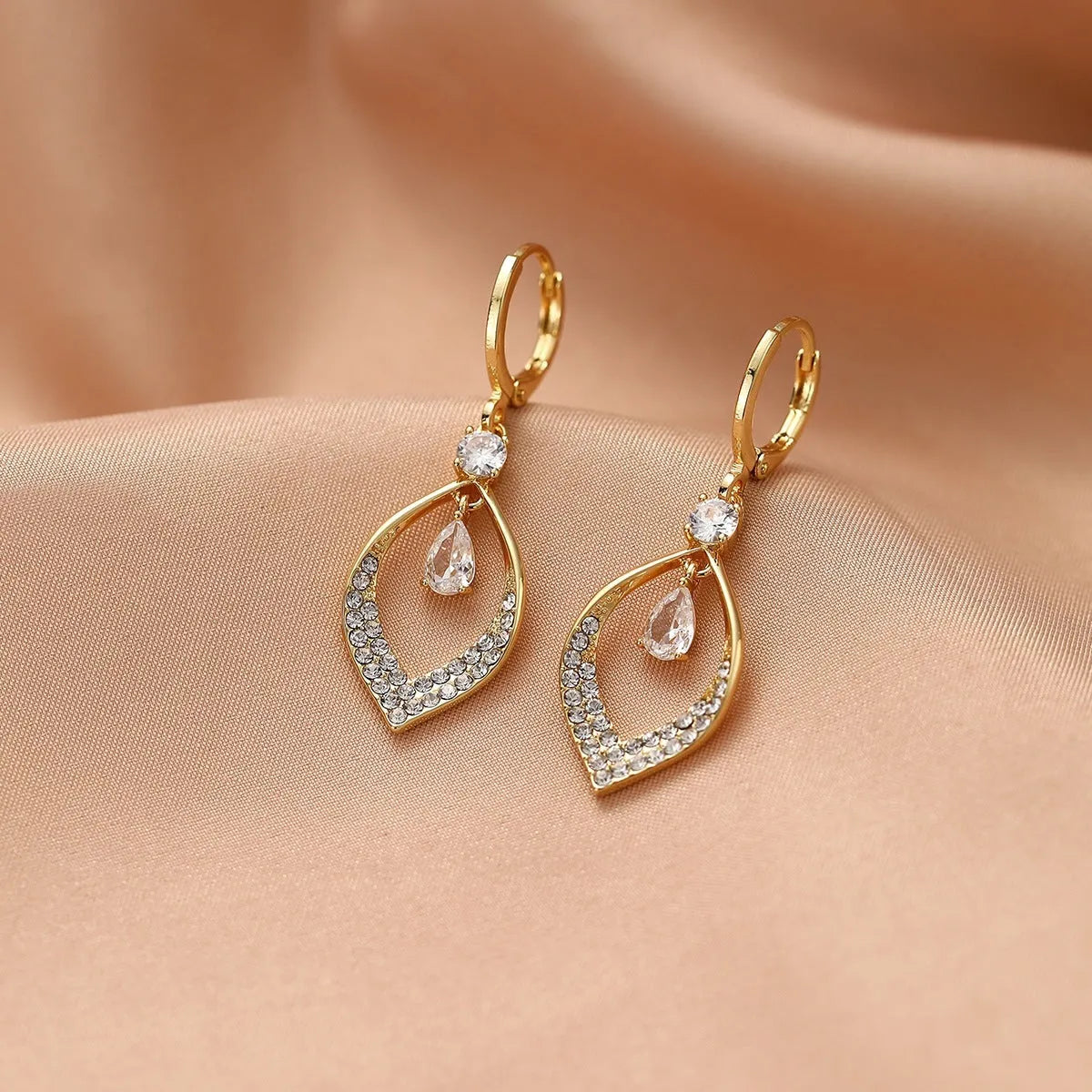 Women's copper teardrop tassel earrings with zircon detail and choice of gold or silver buckle.