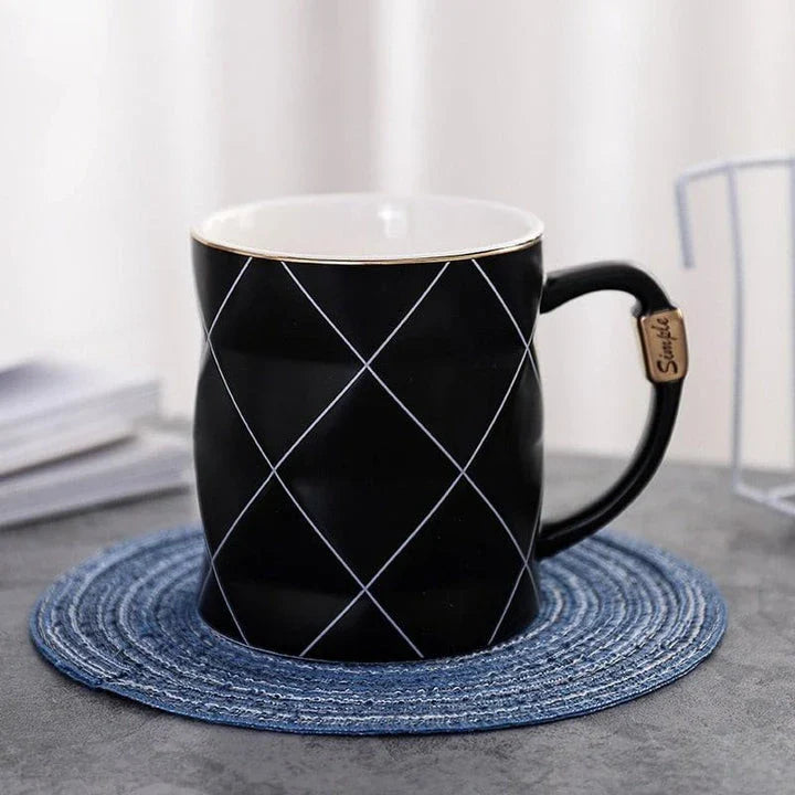 Elegant white ceramic mug with a geometric design, perfect for enjoying your favourite hot or cold beverages