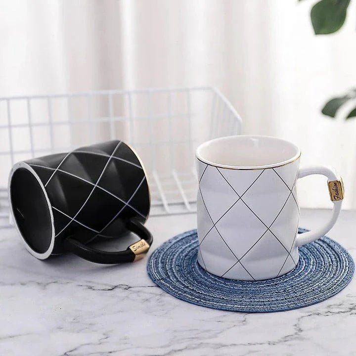 Elegant white ceramic mug with a geometric design, perfect for enjoying your favourite hot or cold beverages