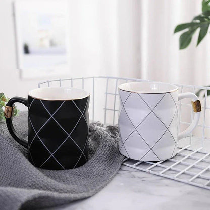 Elegant white ceramic mug with a geometric design, perfect for enjoying your favourite hot or cold beverages