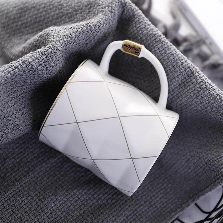 Elegant white ceramic mug with a geometric design, perfect for enjoying your favourite hot or cold beverages