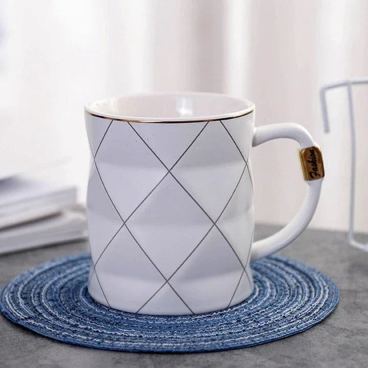 Elegant white ceramic mug with a geometric design, perfect for enjoying your favourite hot or cold beverages
