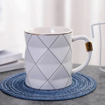 Elegant white ceramic mug with a geometric design, perfect for enjoying your favourite hot or cold beverages