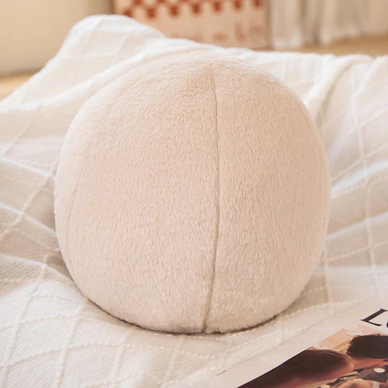 A soft, grey plush toy pillow with a round, furry design that adds a cosy and whimsical touch to home decor.