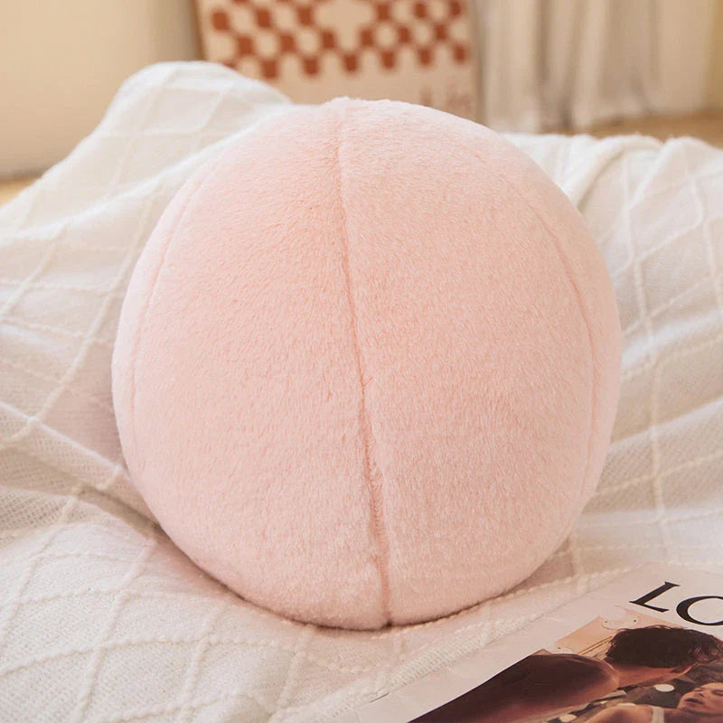 A soft, grey plush toy pillow with a round, furry design that adds a cosy and whimsical touch to home decor.