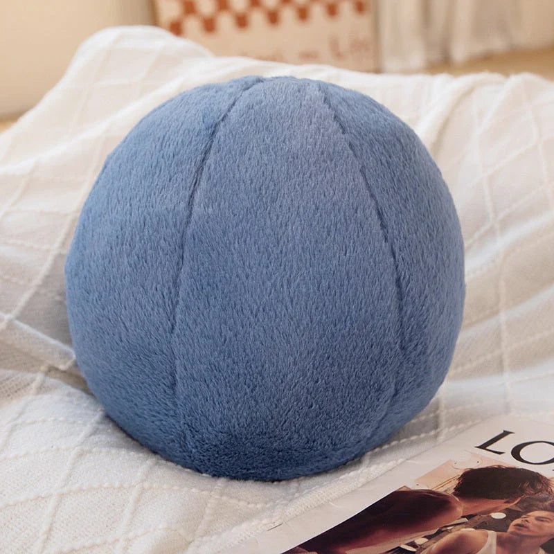 A soft, grey plush toy pillow with a round, furry design that adds a cosy and whimsical touch to home decor.
