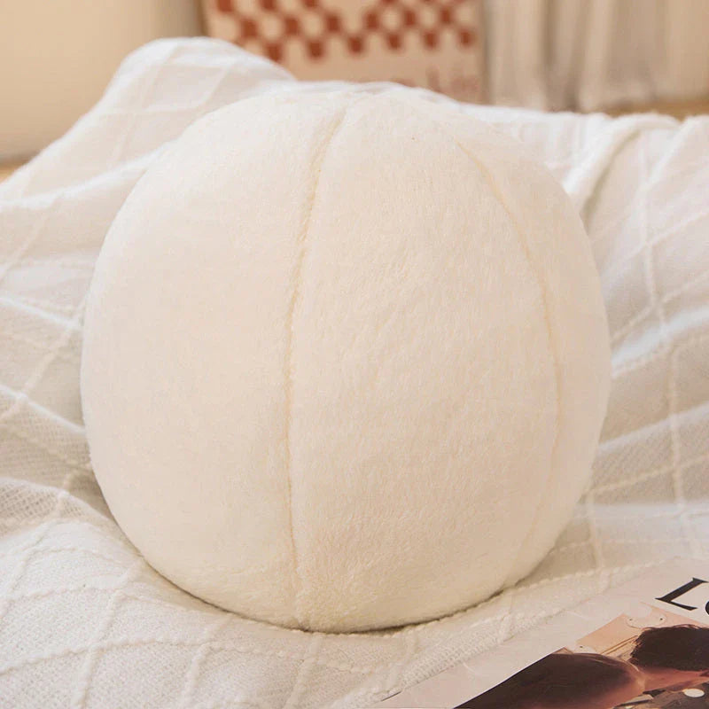 A soft, grey plush toy pillow with a round, furry design that adds a cosy and whimsical touch to home decor.