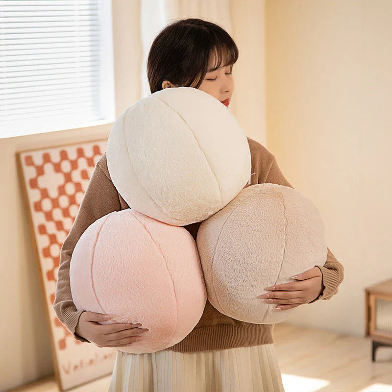 A soft, grey plush toy pillow with a round, furry design that adds a cosy and whimsical touch to home decor.