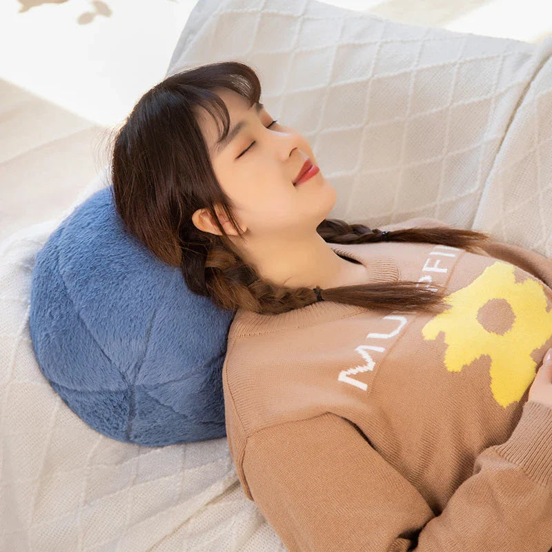 A soft, grey plush toy pillow with a round, furry design that adds a cosy and whimsical touch to home decor.