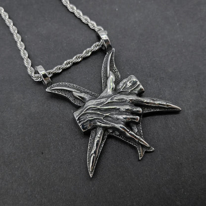 A close-up view of a three-dimensional pendant necklace made of titanium steel, showcasing its sleek and sophisticated design.