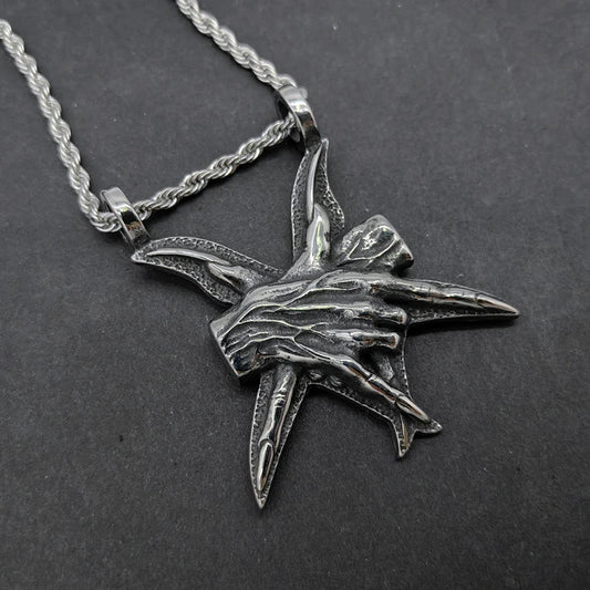 A close-up view of a three-dimensional pendant necklace made of titanium steel, showcasing its sleek and sophisticated design.