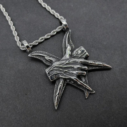 A close-up view of a three-dimensional pendant necklace made of titanium steel, showcasing its sleek and sophisticated design.