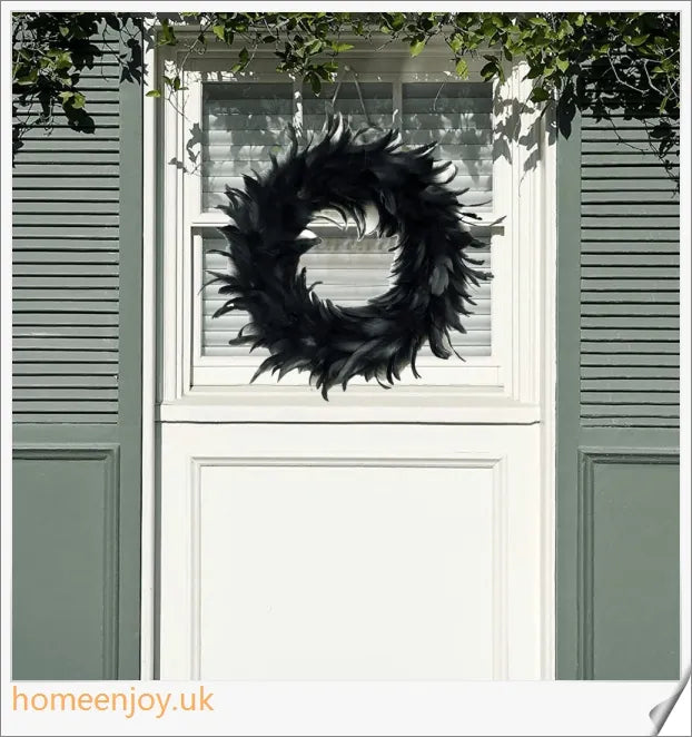 Black Halloween wreath made of luxurious natural feathers in shades of onyx, green, and purple