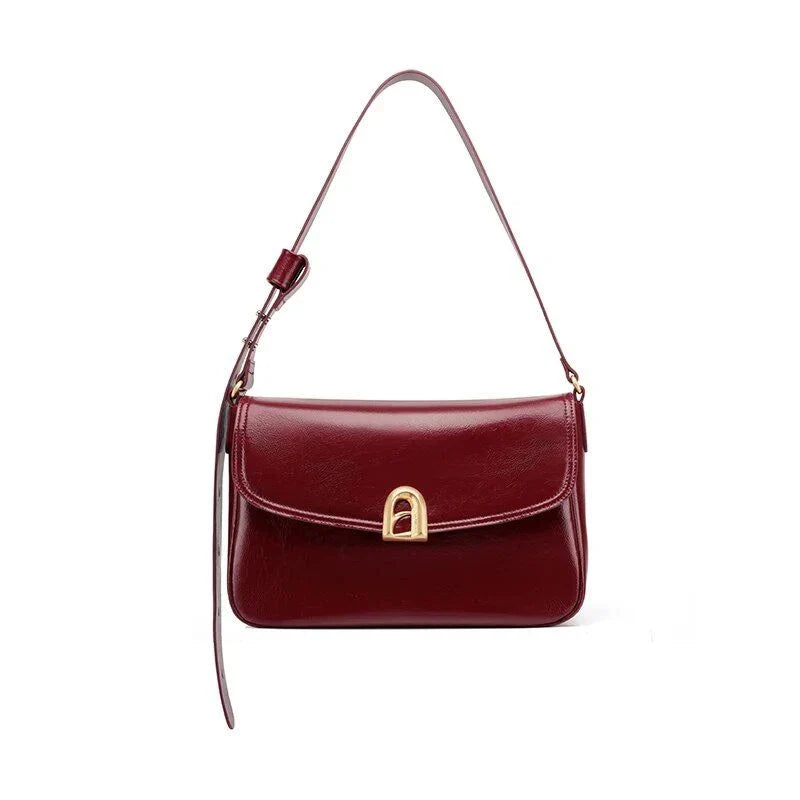 Elegant square-shaped burgundy leather shoulder and crossbody bag for women, featuring a modern design and spacious interior.