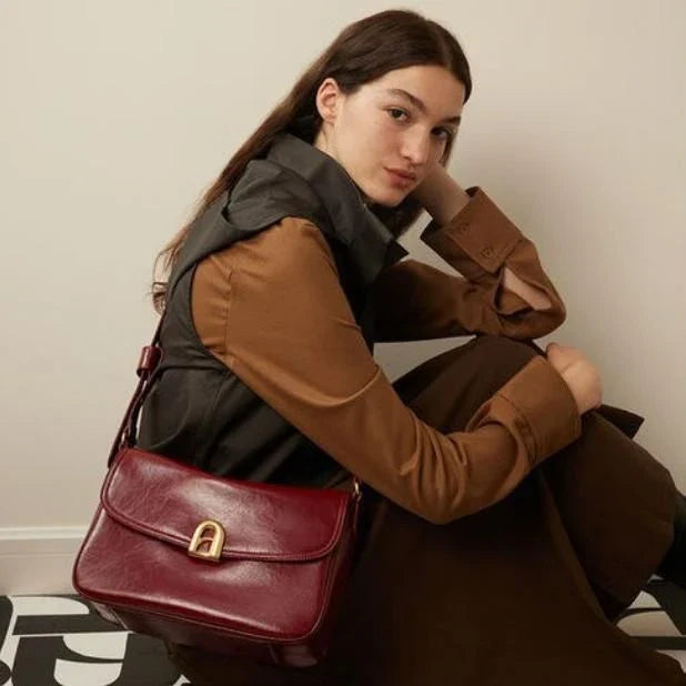Elegant square-shaped burgundy leather shoulder and crossbody bag for women, featuring a modern design and spacious interior.